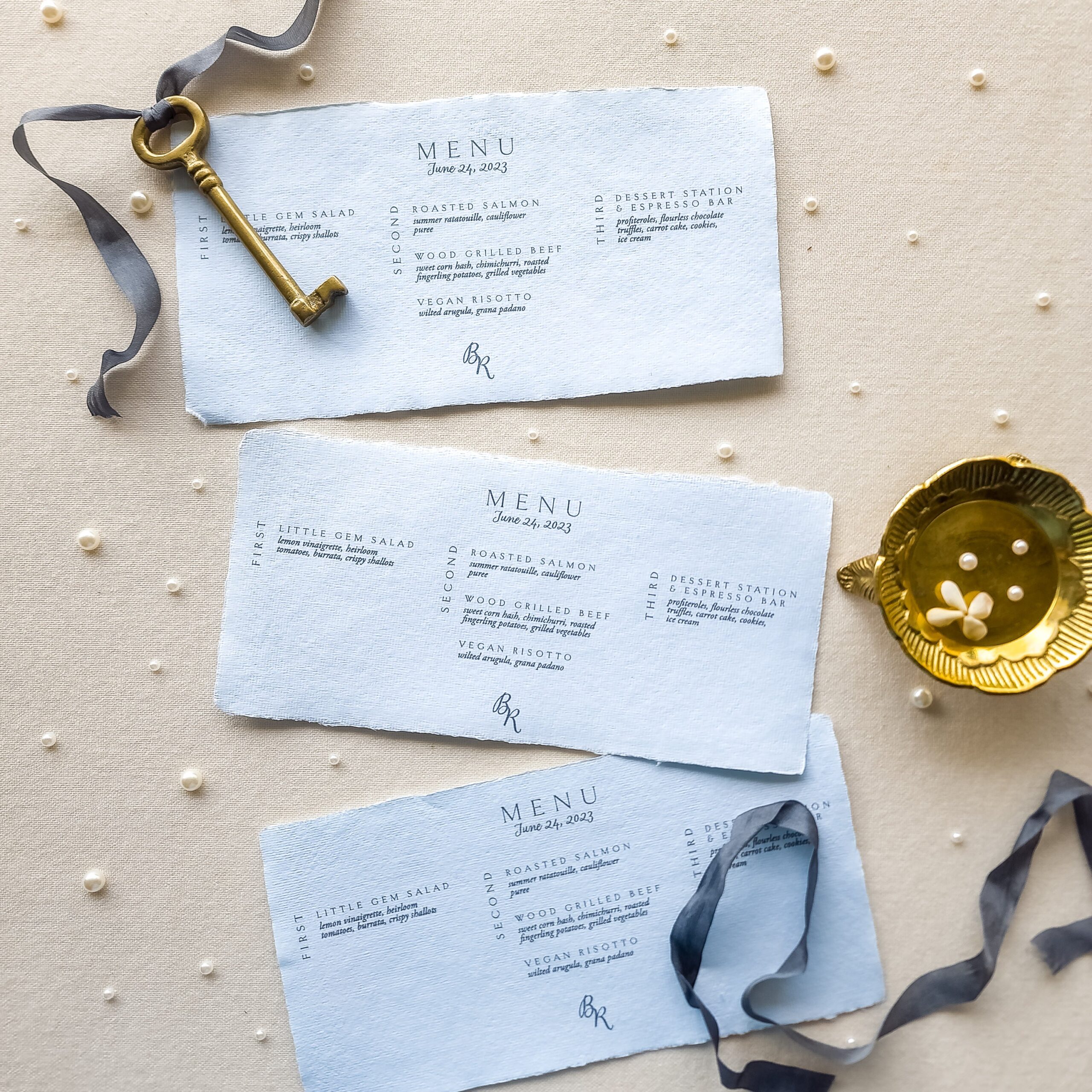Blue and white invitation suite with a monogram and coordinated envelopes