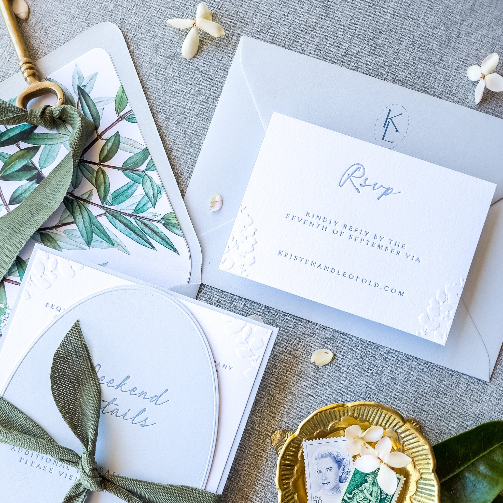 Blue and white wedding invitation suite with an embossed monogram detail