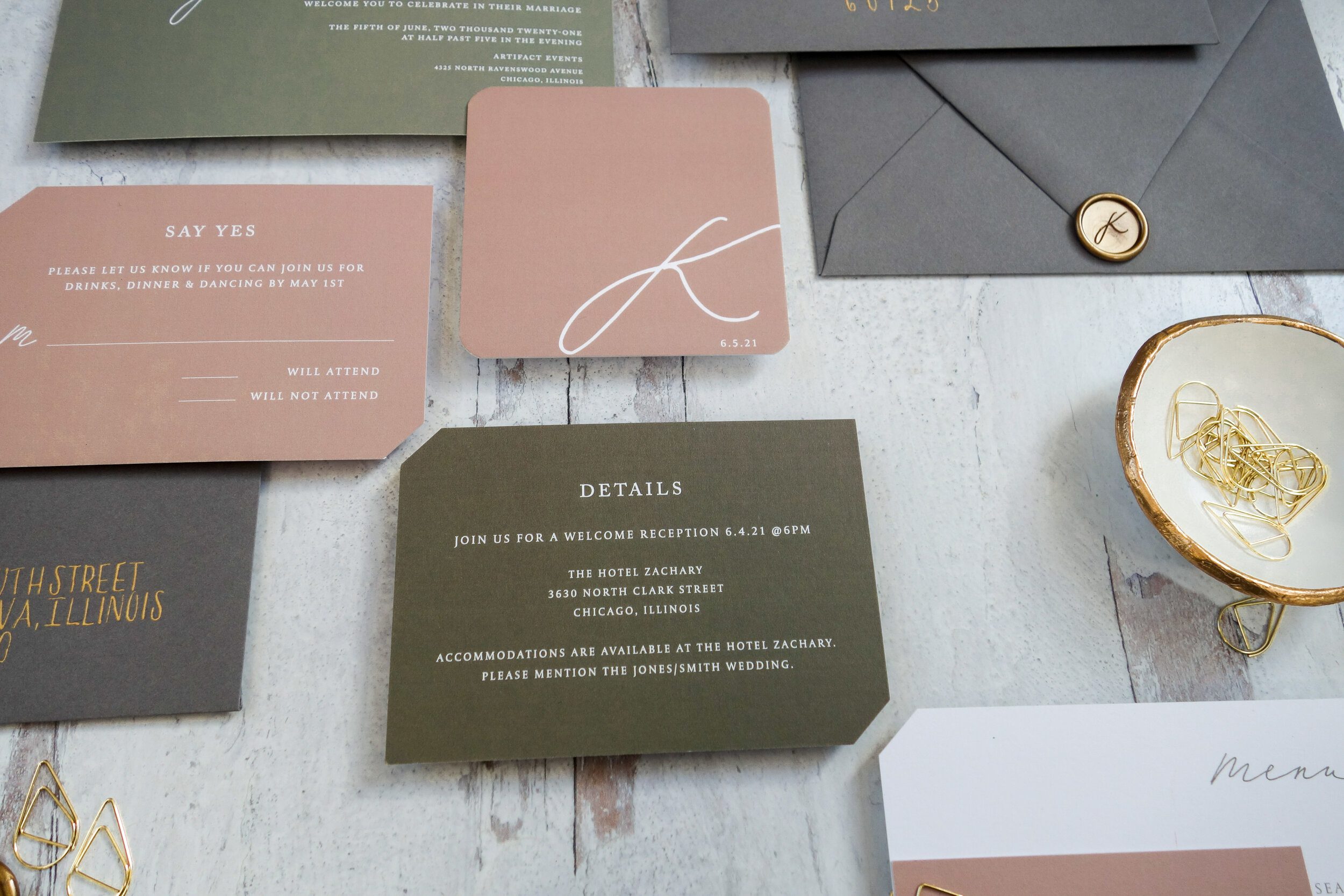 Blush monogram card beside a gray envelope and wax seal