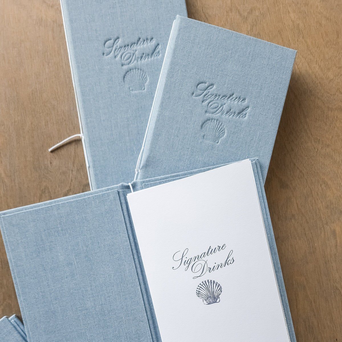Blue wedding programs and white menus with a matching monogram