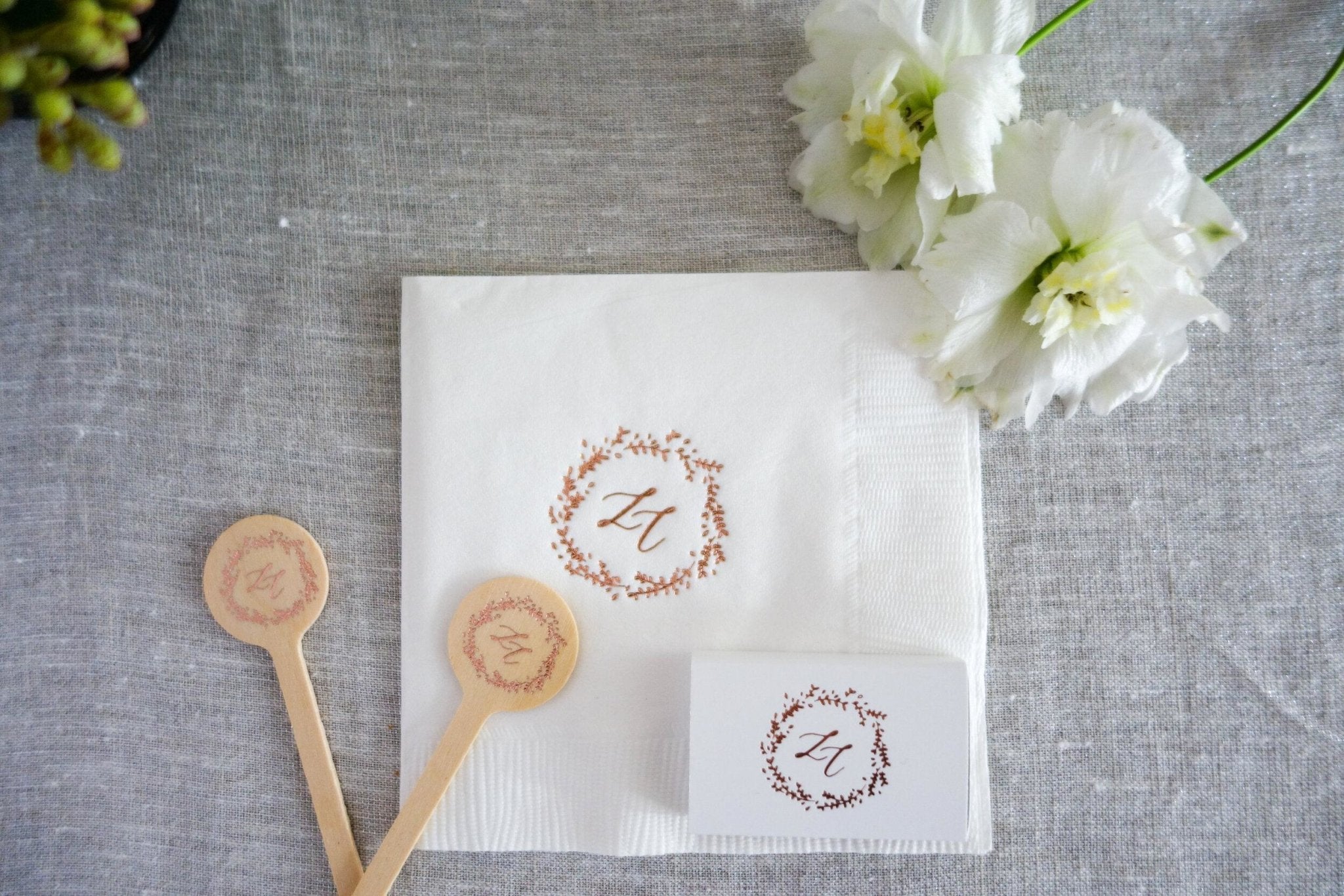 Floral wedding monograms on paper beside wax seals