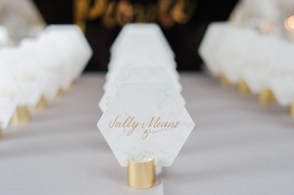 Marble-inspired paper escort cards with gold calligraphy at LondonHouse Chicago