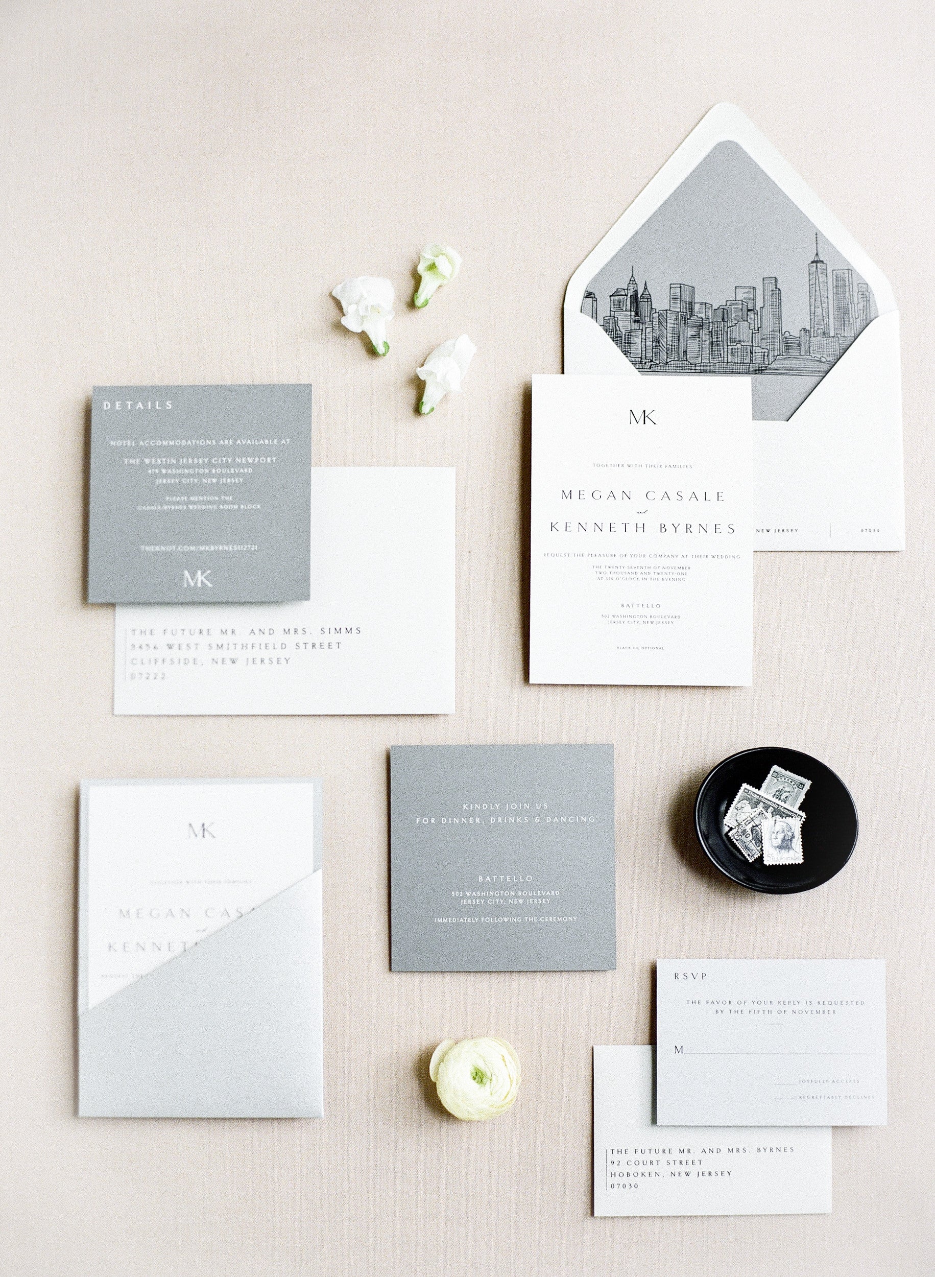 Minimal white invitation suite with a gray pocket and illustrated liner