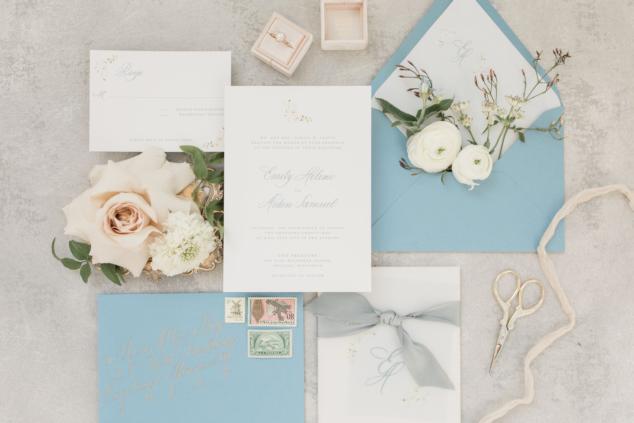Soft blue spring wedding invitations with floral artwork and silk ribbon