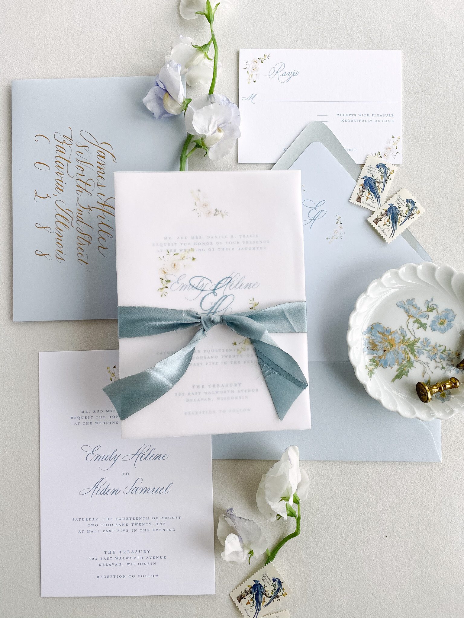 Wedding invitation gathered in a vellum wrap with green ribbon